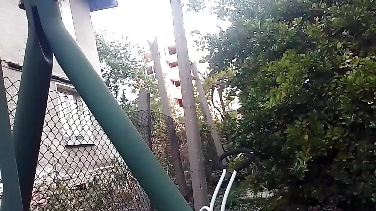 Horny slut riskily shows her tits in the yard